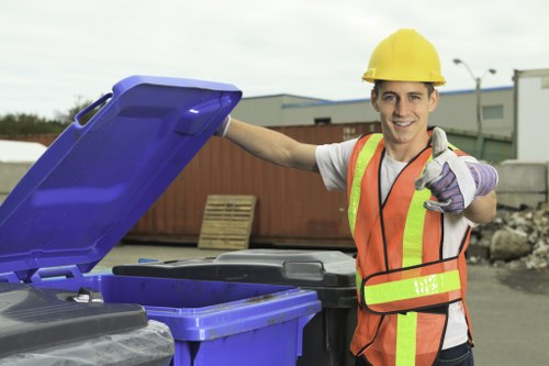 Staff sorting recyclable materials into labelled containers