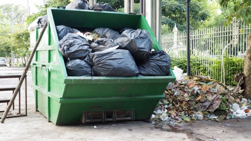 Professional waste clearance service truck at a construction site.