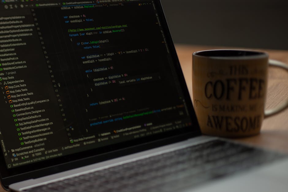 A photograph of a computer screen displaying lines of HTML code with syntax highlighting, including tags such as <head>, <body>, and <img>. The code is slightly blurred and features various colors inc